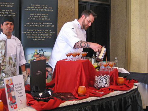 Truluck's executive chef Nate Boothe pours his tomato gazpacho mini-martinis with blueberry balsamic reduction and crab finger