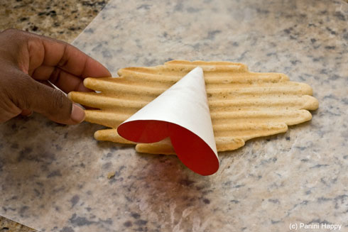 Lay your cone mold on the hot cookie - gotta work quickly!