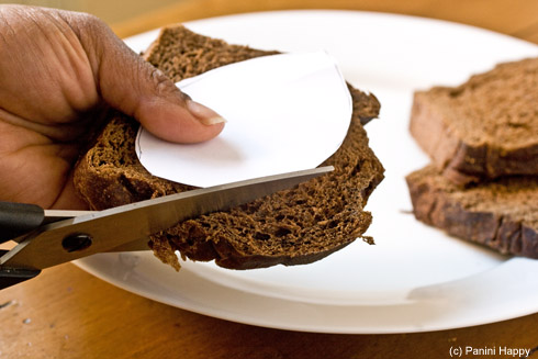 Draw a football-shaped template on a piece of paper and cut the shape out of bread with kitchen shears